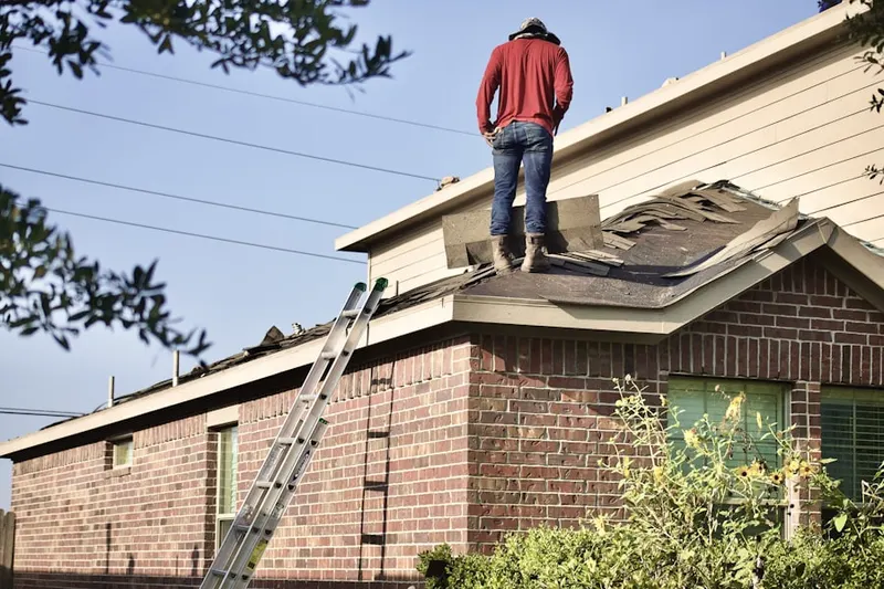 Professional roofer working on a residential roof in Slateville